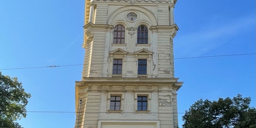 The tower was built in 1882 in Neo-Renaissance style according to the project by architect Antonin Turek. At that time it was part of the water supply system of the town of King's Vinohrady, which consisted of the waterworks in Podol, underground water tanks, a pumping station, and a tower water tank on Korunni street in Vinohrady.